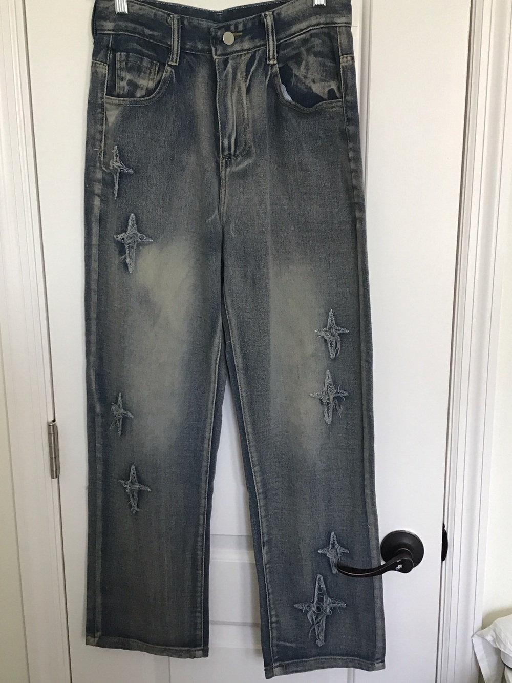 Distressed star decorated jeans.